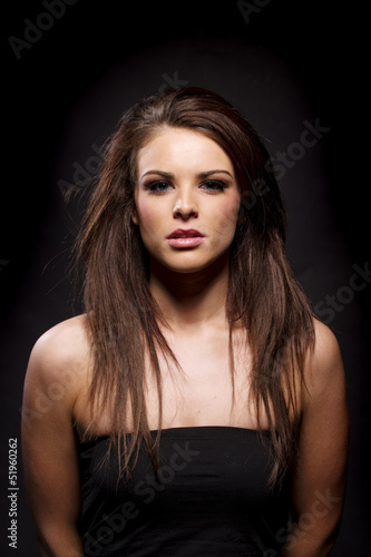 Beautiful brunette woman on a black background