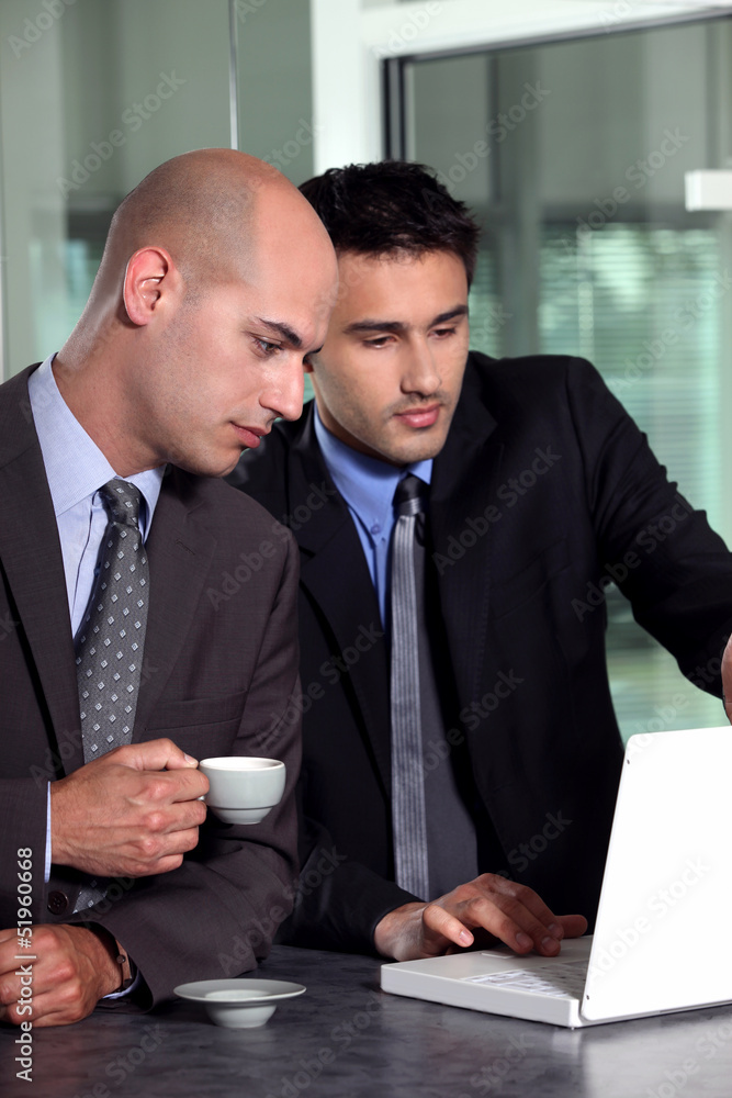 Businessmen looking at a laptop Businessmen looking at a laptop