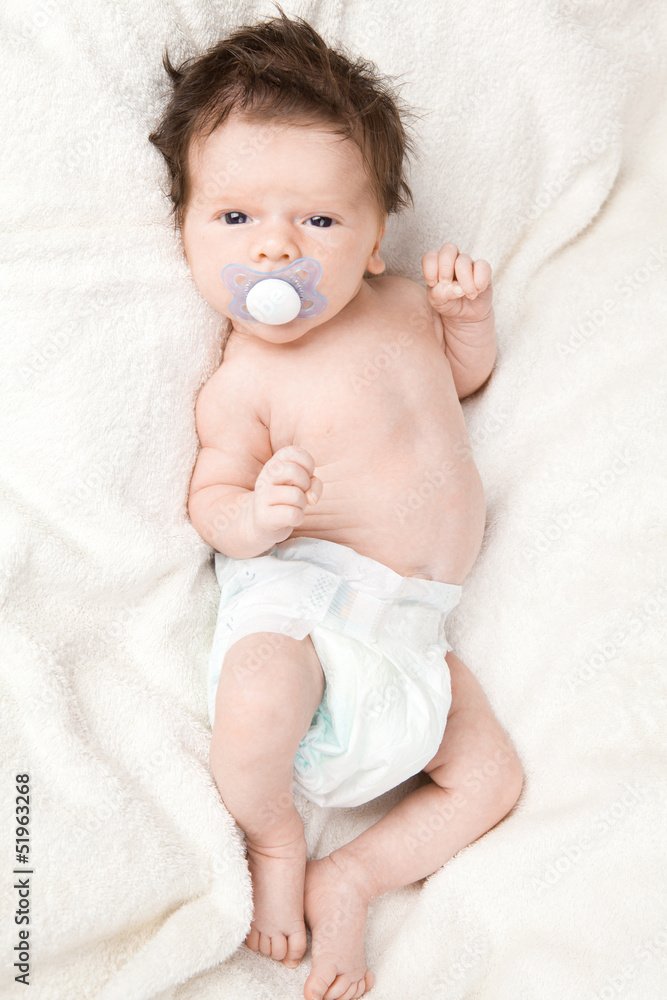 Cute baby boy with dark hair. Stock Photo | Adobe Stock