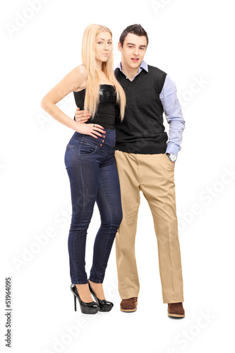 Full length portrait of a young couple standing together and loo