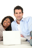 Couple at home with a laptop