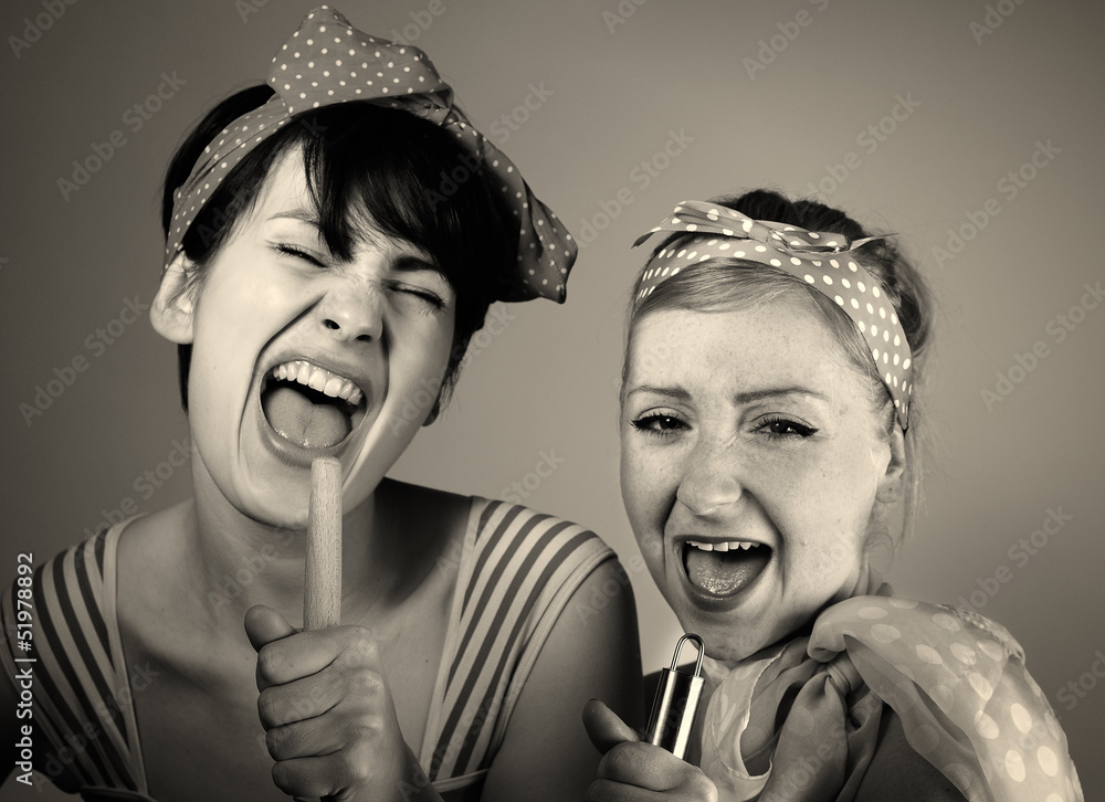 Two women singing together. Karaoke, retro style.