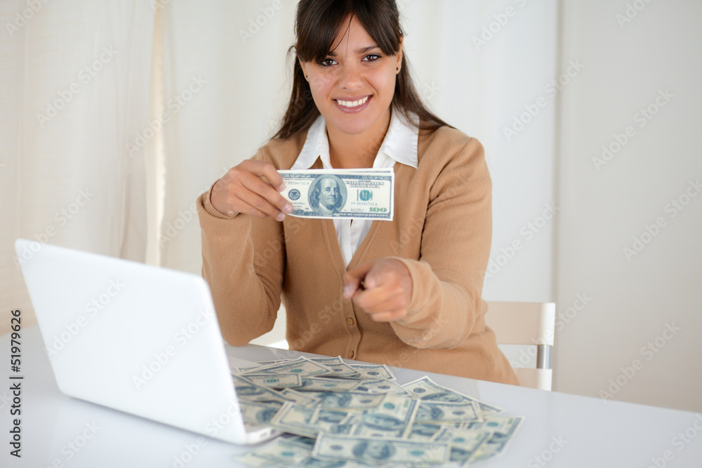Young woman holding and showing you cash dollars Young woman holding and showing you cash dollars