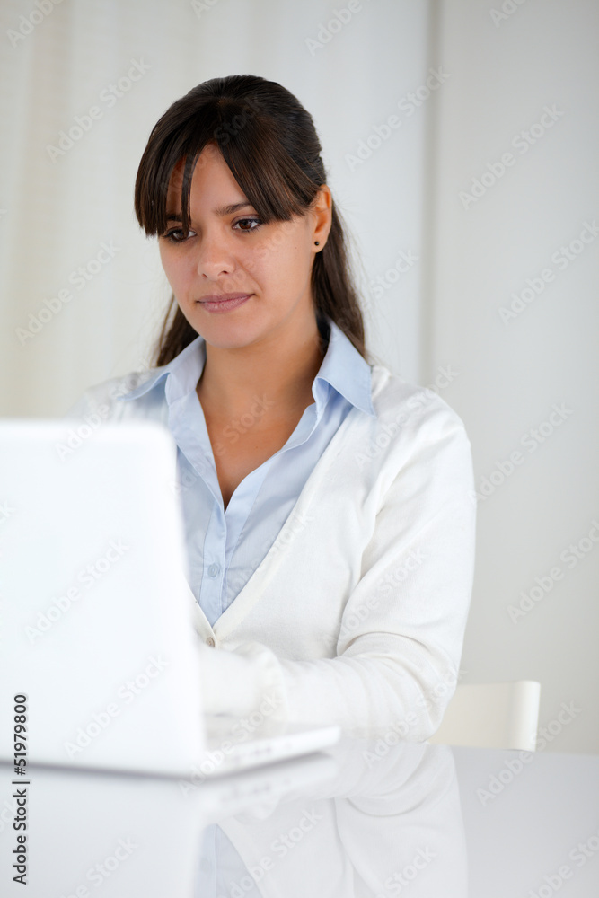 Charming young woman working on laptop computer Charming young woman working on laptop computer