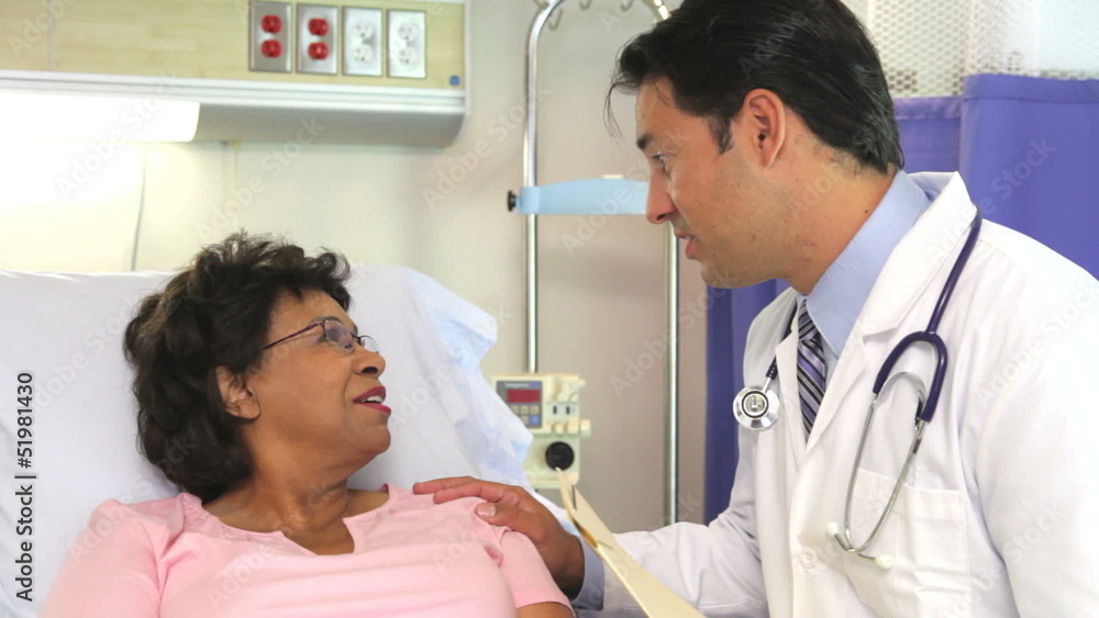 Doctor Talking To Senior Female Patient In Hospital Bed Doctor Talking To Senior Female Patient In Hospital Bed