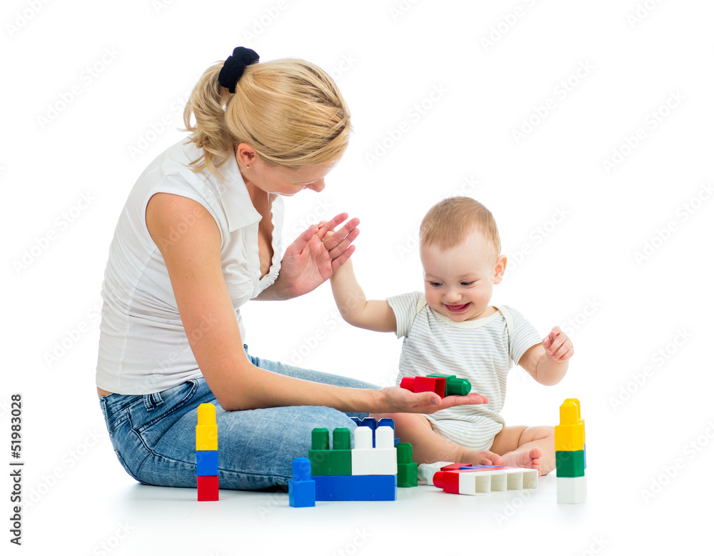 baby boy and mother playing together with construction set toy
