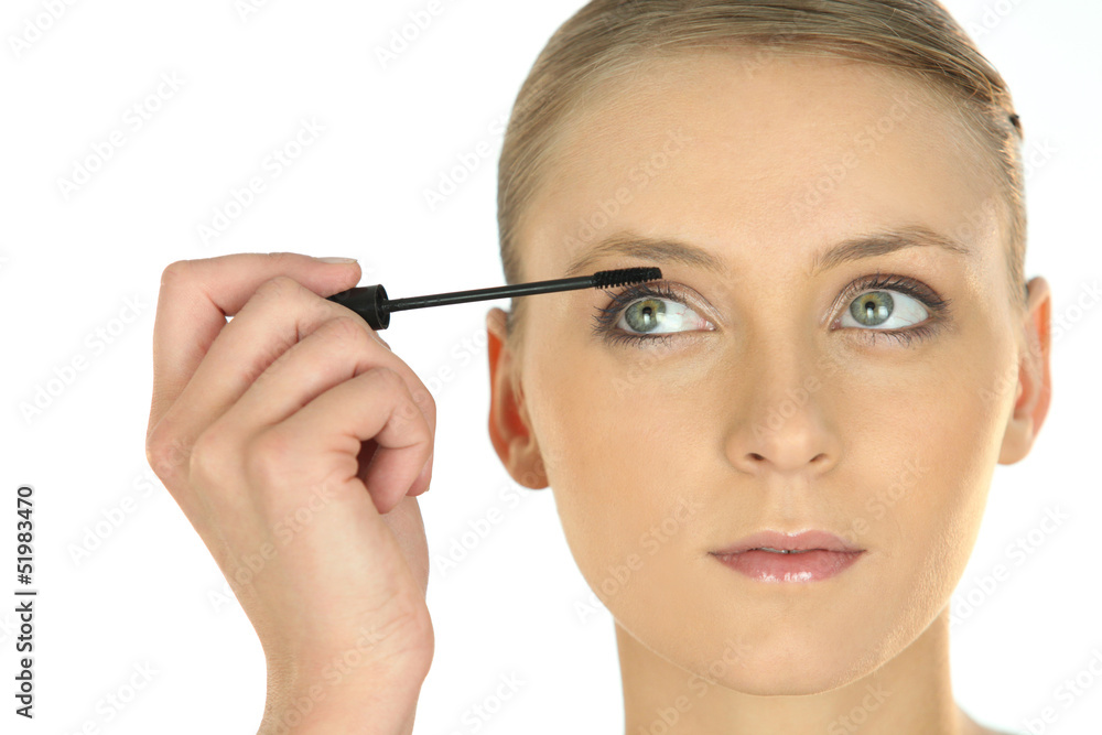 Blond applying mascara
