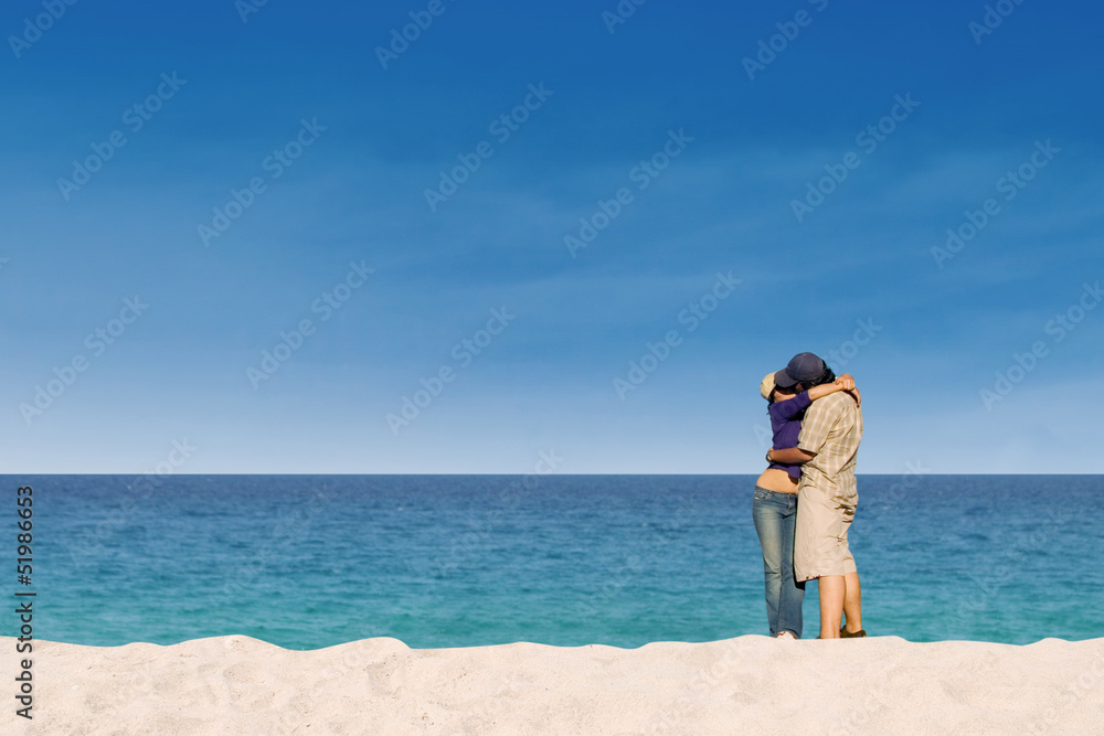 Romantic couple kissing at paradise beach