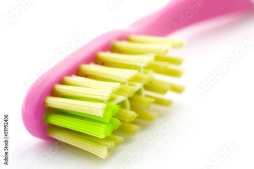 Toothbrush closeup on white background.