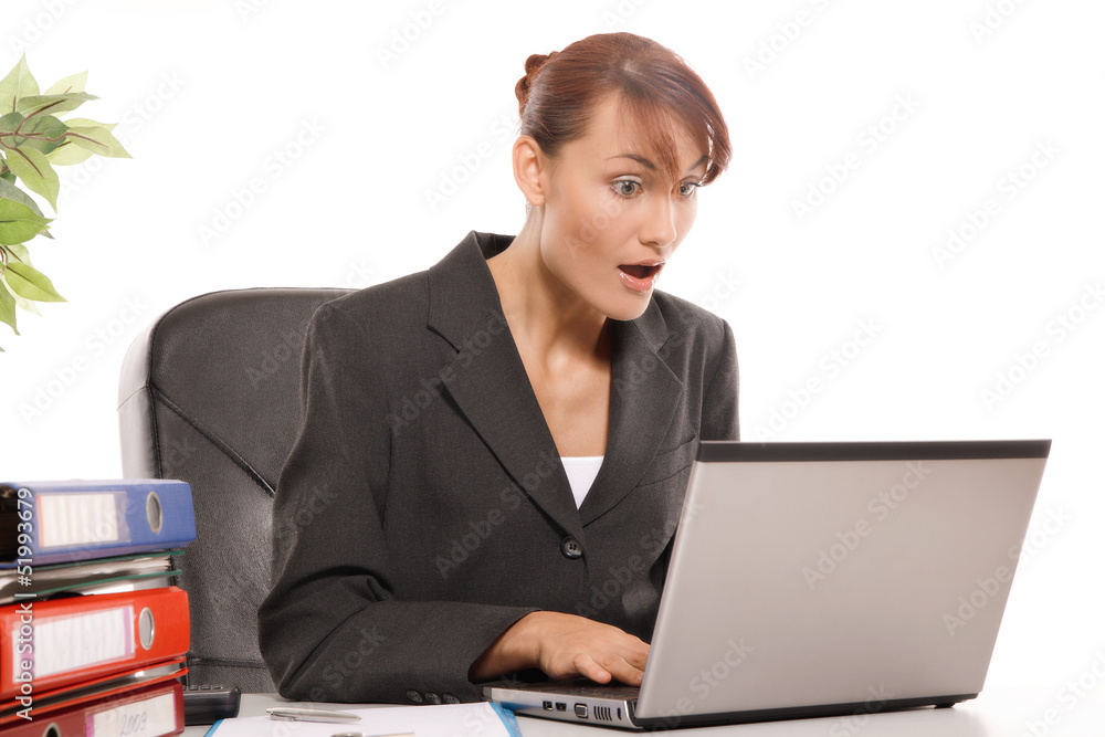 Young woman is shocked by what she sees on the monitor Young woman is shocked by what she sees on the monitor
