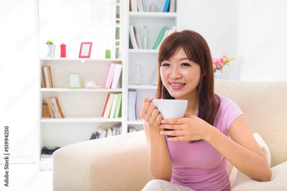 Chinese Asian female enjoying cup of coffee Chinese Asian female enjoying cup of coffee