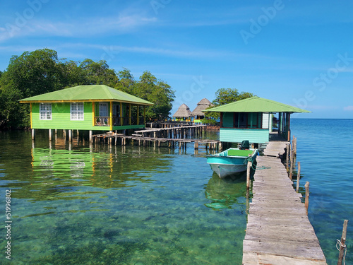 Tropical resort over the water with wooden dock and bungalows, Caribbean sea, Bocas del Toro, Panama © dam