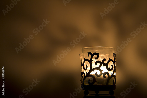 Obraz na plátne Jar candle holder on a golden background