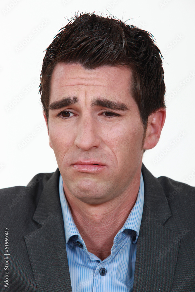 A businessman frowning. A businessman frowning.
