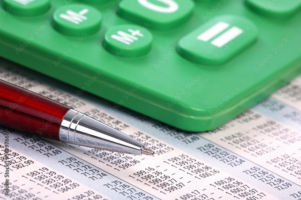 Calculator and pen on a business background