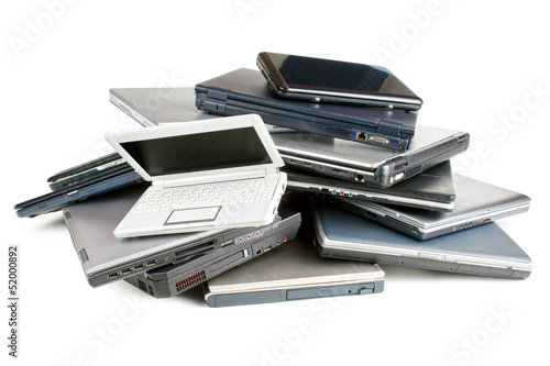 Obraz na płótnie Stack of different sized and aged laptops, isolated w salonie