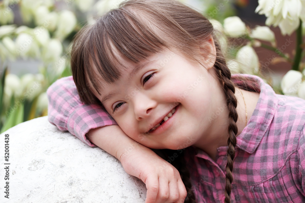 Portrait of smiling girl on flowers background Portrait of smiling girl on flowers background