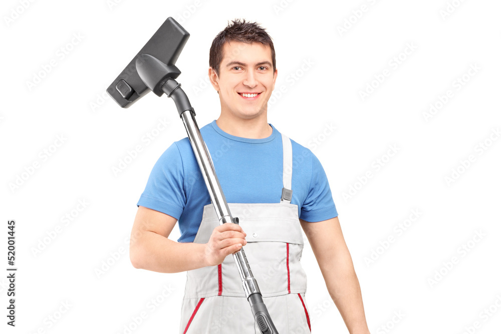 A young male worker holding a vacuum cleaner A young male worker holding a vacuum cleaner