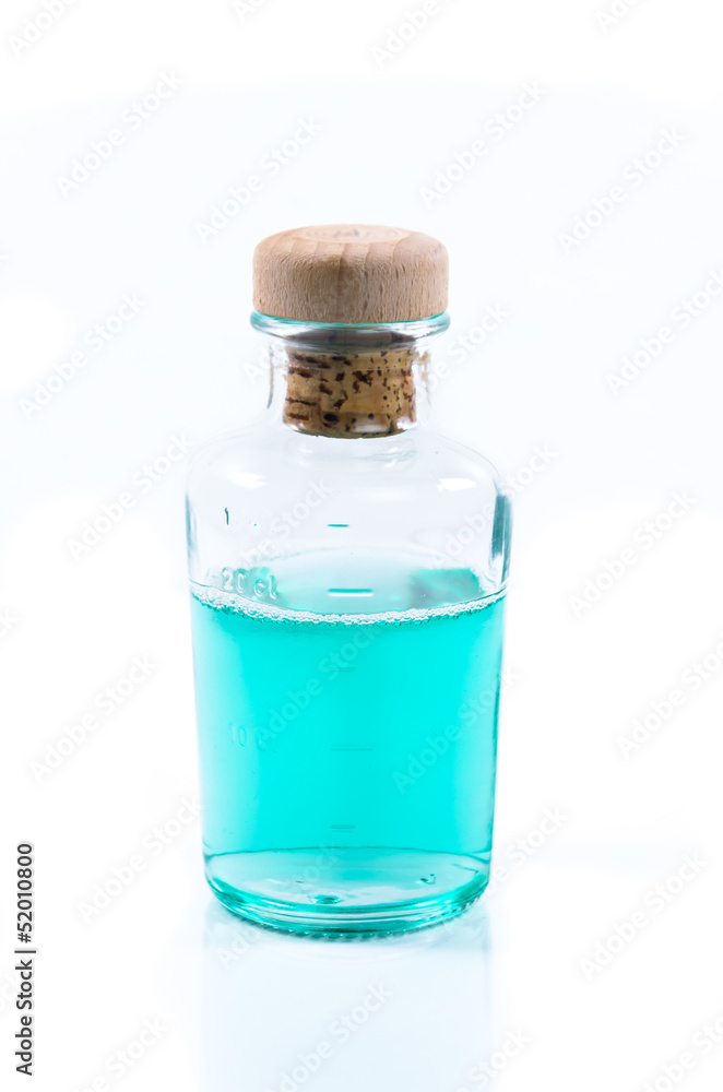 Glass bottle of turquoise blue liquid