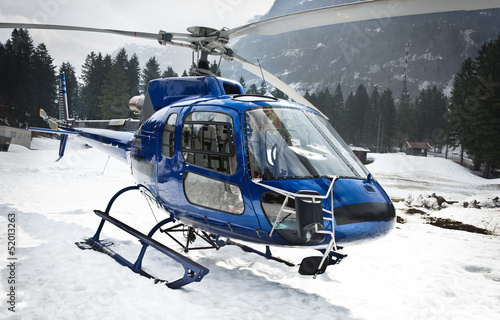 helicopter resting on the snow - front