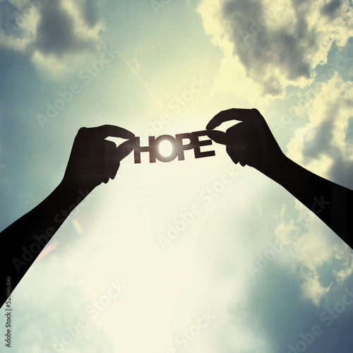 holding paper cut of hope photo