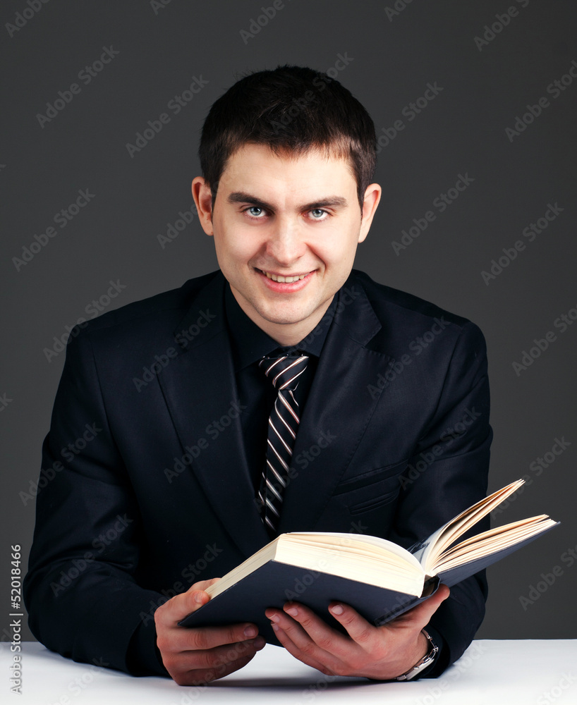 businessman which reads book at desk businessman which reads book at desk