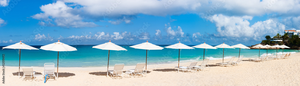 Chairs and umbrellas on tropical beach