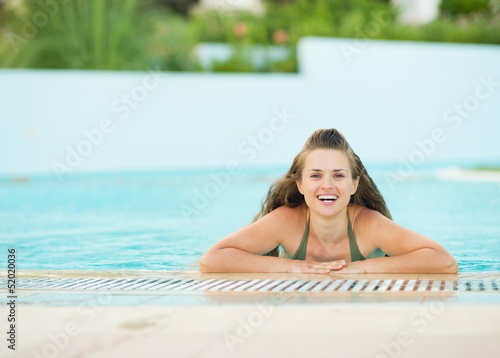 Portrait of smiling young woman in pool