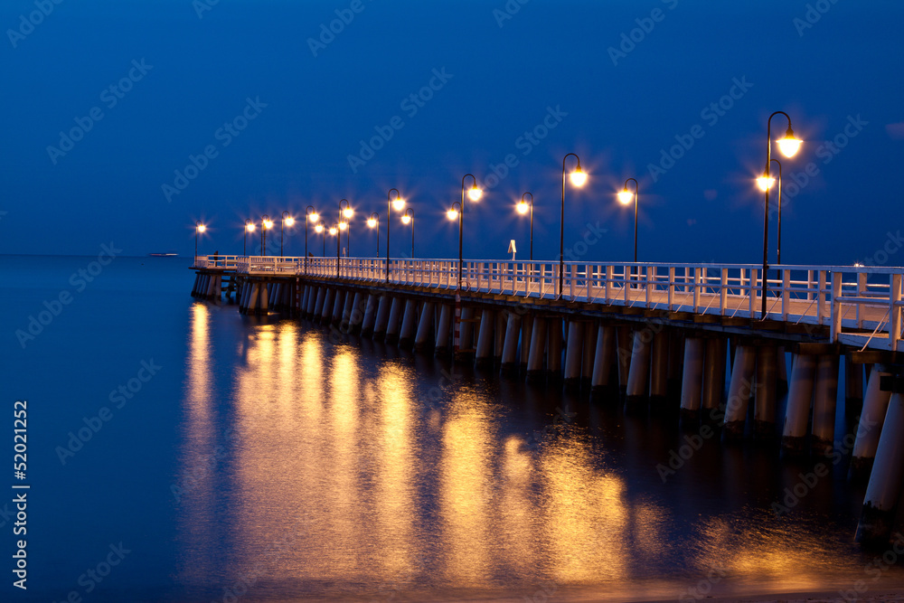 Sunrise on the pier at the seaside, Gdynia Orlowo, Poland.