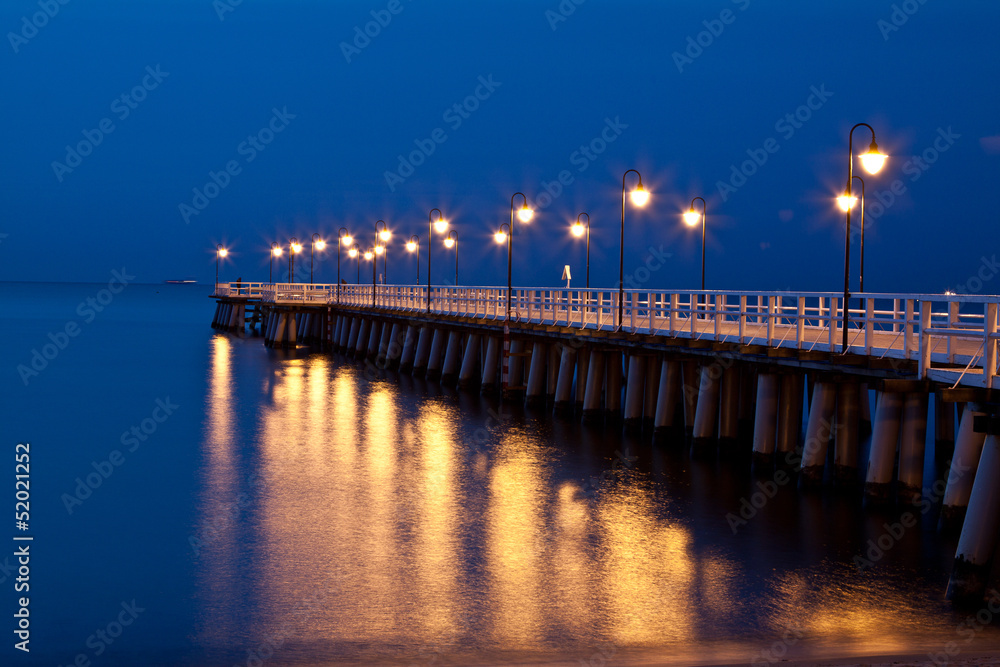 Fototapeta premium Sunrise on the pier at the seaside, Gdynia Orlowo, Poland.