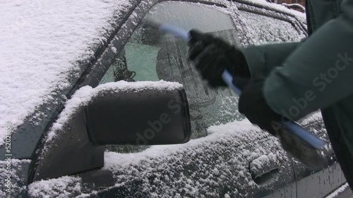 Scraping ice off car. Toronto, Ontario.