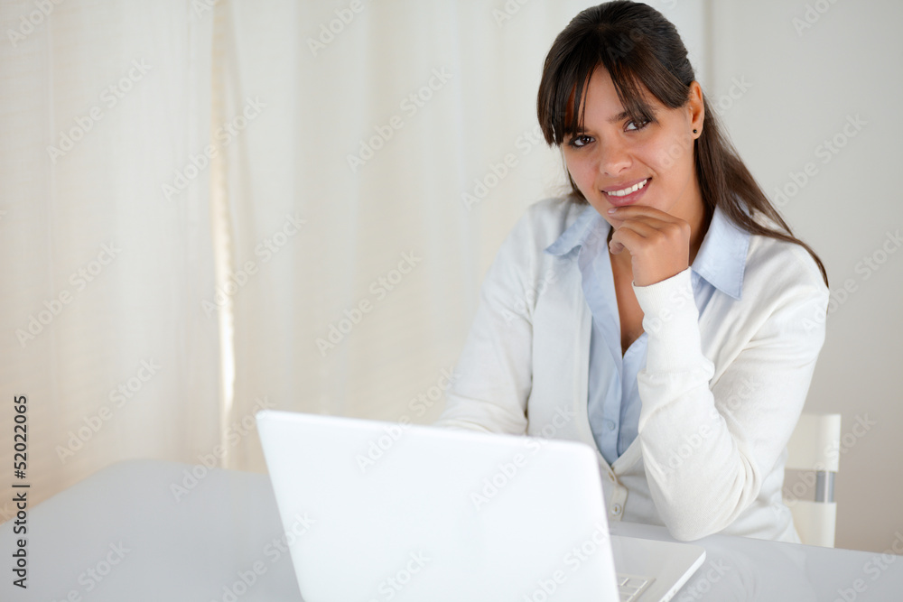 Charming young woman looking at you using laptop Charming young woman looking at you using laptop