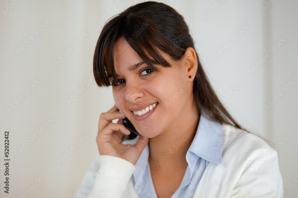 Smiling young woman looking at you with cellphone Smiling young woman looking at you with cellphone