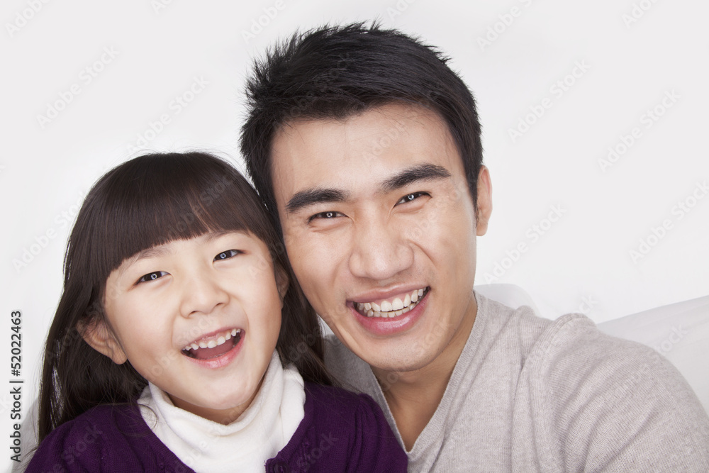 Portrait of father and daughter, studio shot Portrait of father and daughter, studio shot