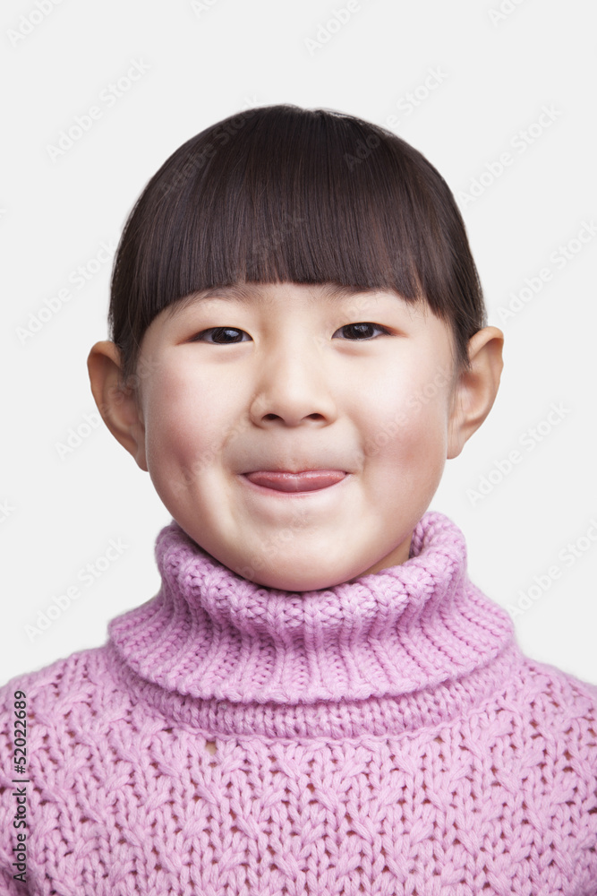 Portrait of smiling little girl sticking tongue out, studio shot Portrait of smiling little girl sticking tongue out, studio shot