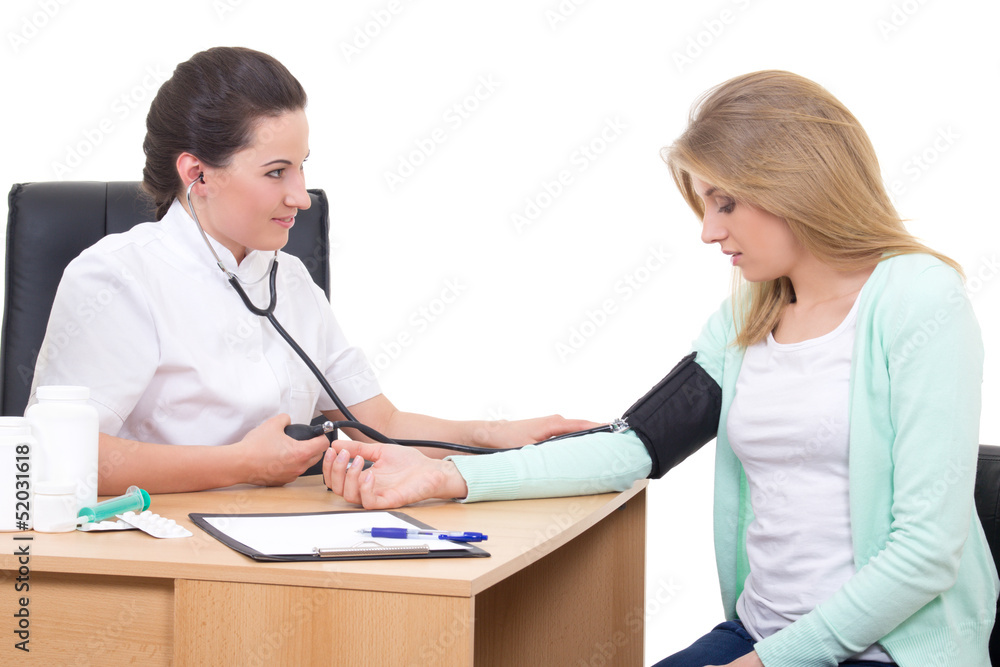 female doctor measuring blood pressure of young woman