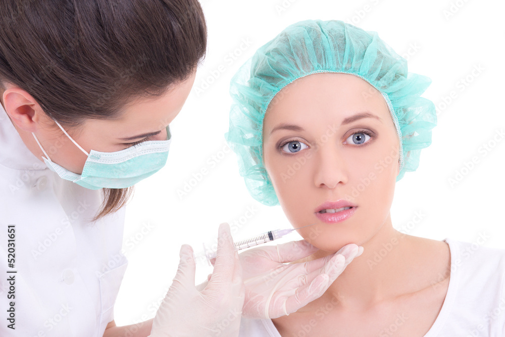 female doctor giving an injection on the young woman's face female doctor giving an injection on the young woman's face
