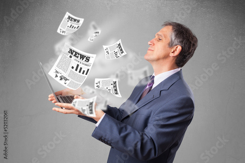 Middle aged businessman holding notebook and reading the explosi photo