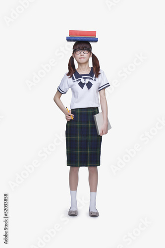 School Girl with Books on Head