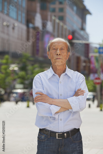 Portrait of senior man, arms crossed, outdoors in Beijing 
