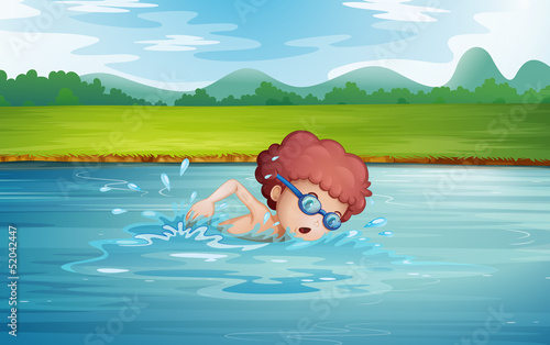 A boy swimming at the river with goggles
