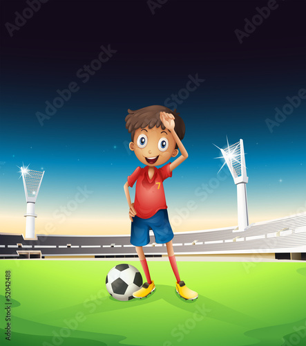 A field with a soccer player in a red uniform