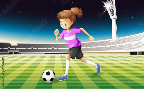 A girl at the field playing football