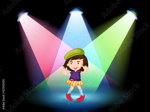 A stage with a young girl dancing