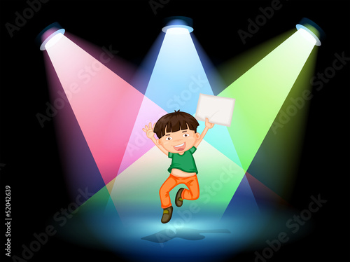 A young boy at the stage holding an empty paper