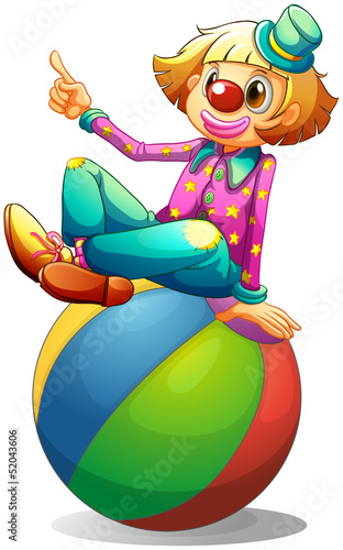 A clown sitting on a ball