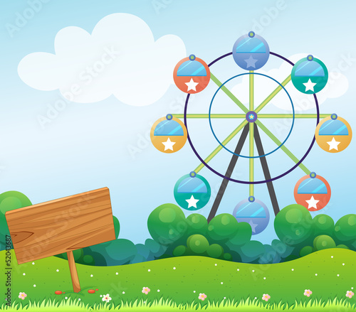 A wooden signboard with a ferris wheel at the back