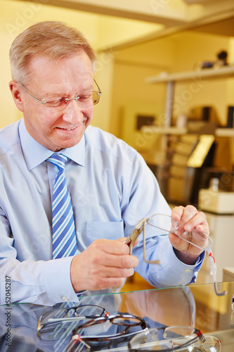 Optician repairing glasses photo