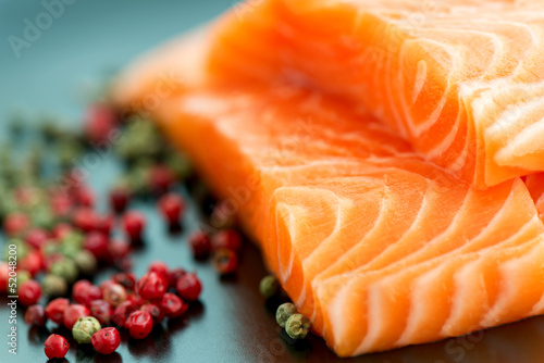 Photography Raw salmon ready to cook close up on black surface