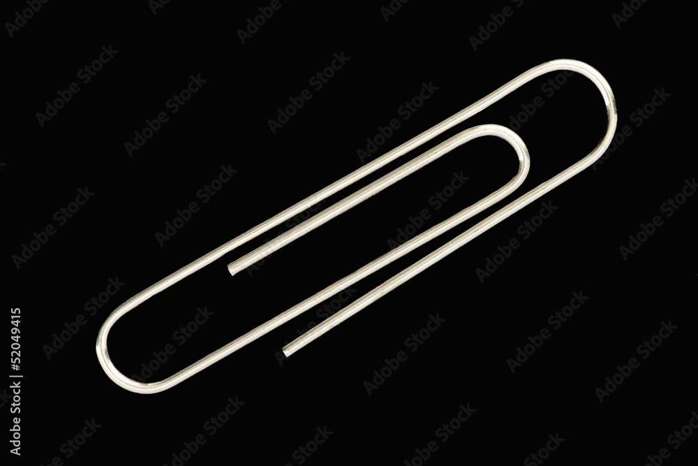 Obraz premium Single paperclip, black background